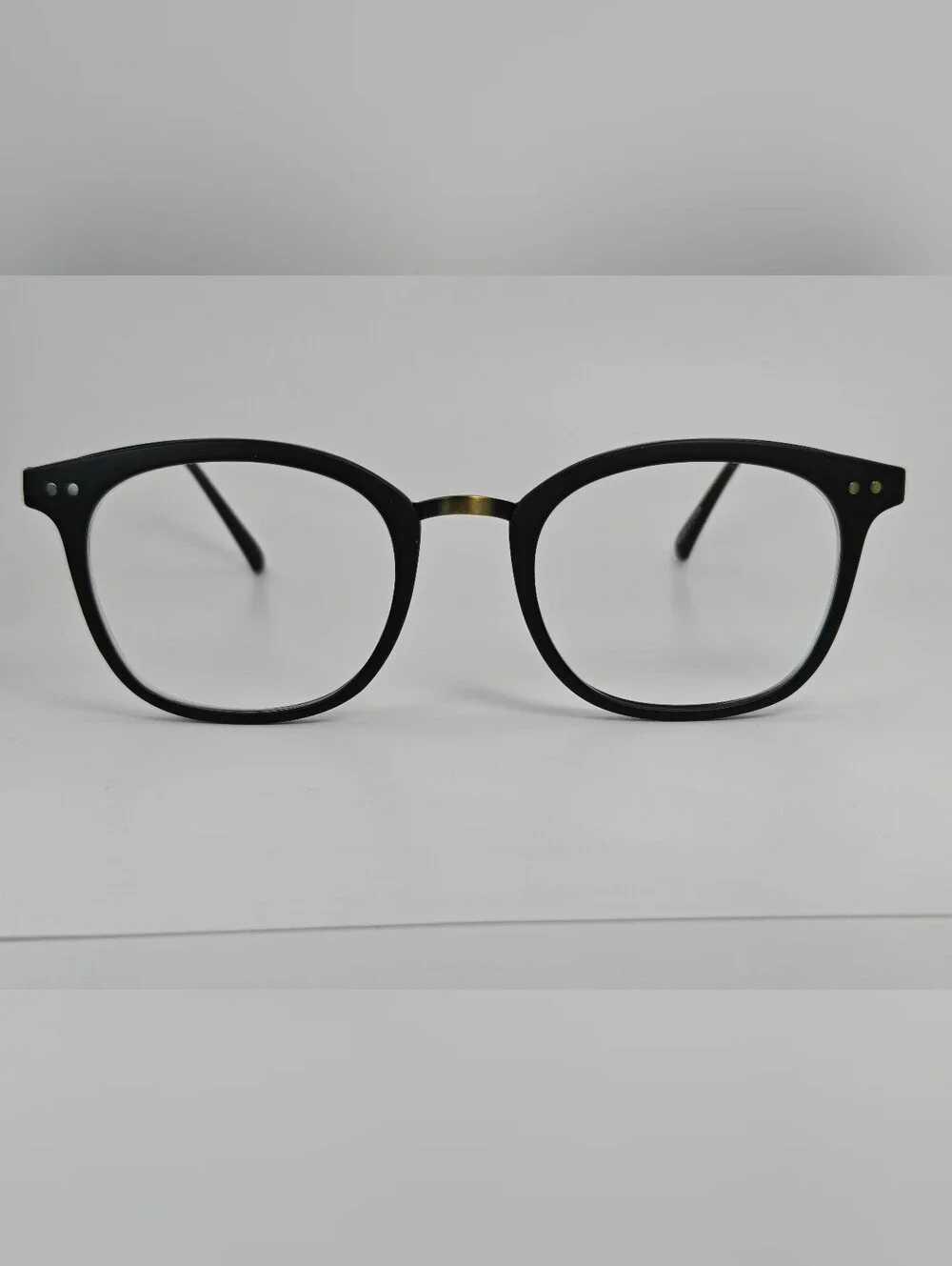 Lyric. Classic Black Round Women's Eyeglasse. Subtle Gold Bridge, Gold Temple.